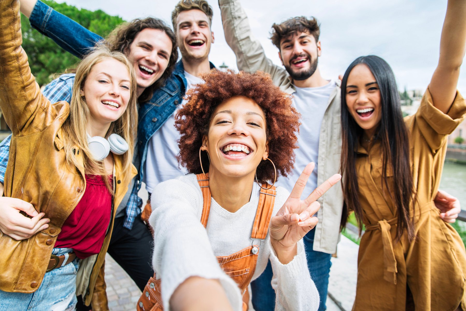 Multiracial group of friends taking selfie pic outside - Happy d